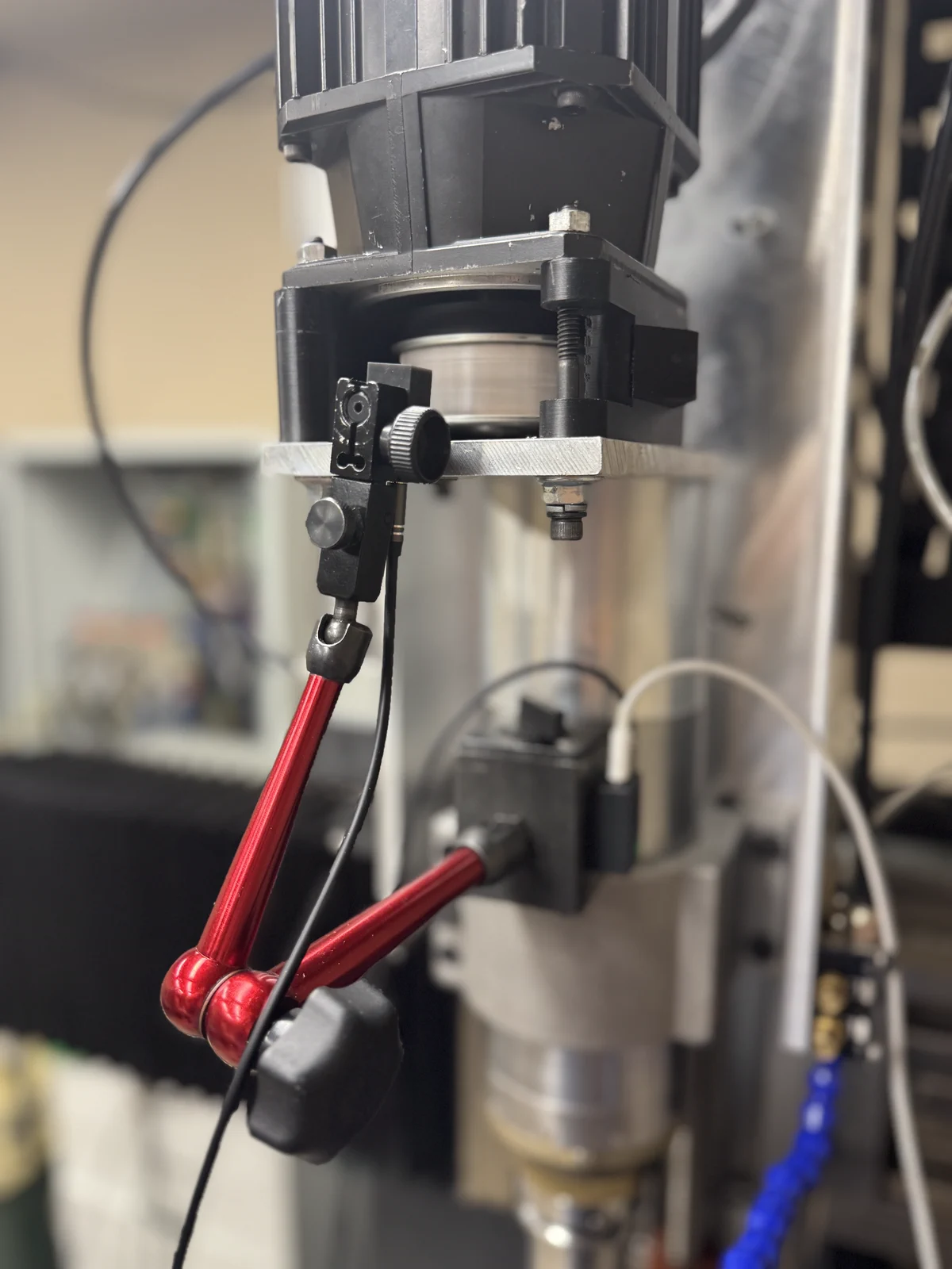 Close view of the IR tach eye aimed squarely at the spindle target from a dial indicator stand